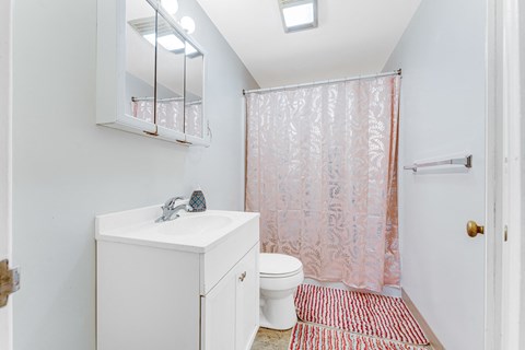 A white sink and toilet in a small bathroom.