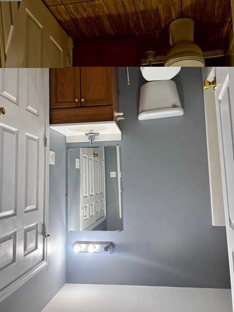 A bathroom with a white toilet and a mirror above it.