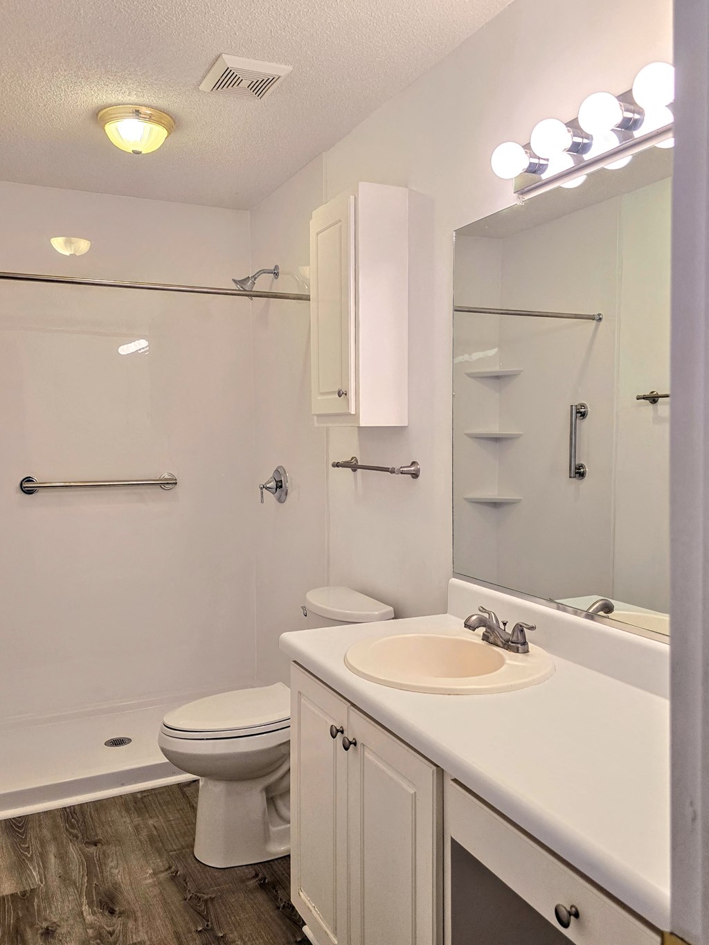 a bathroom with a sink toilet and a shower