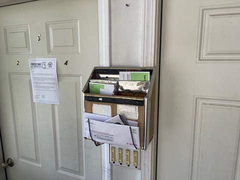 a filing cabinet with boxes and papers on a door