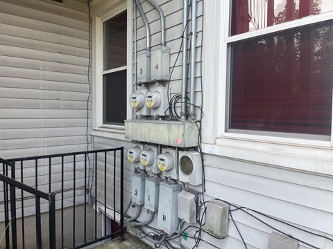 a bunch of meters on the side of a house
