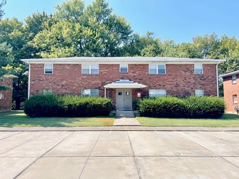 a brick building with a sidewalk in front of it