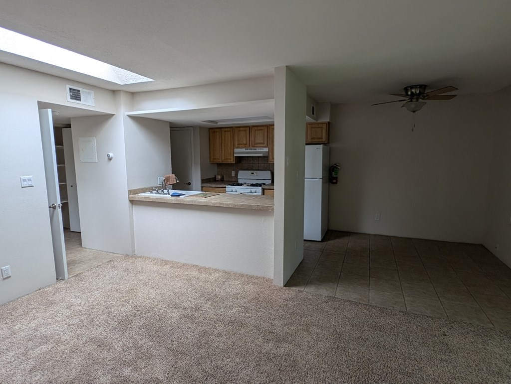 the living room and kitchen of an empty house
