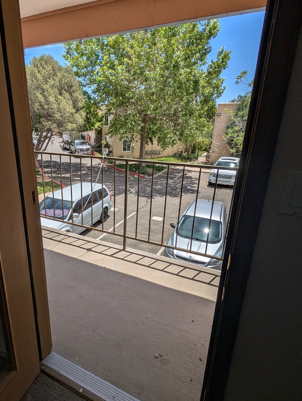 a view from a door of cars parked in a parking lot