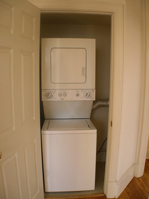 A white dishwasher and oven are in a small space.