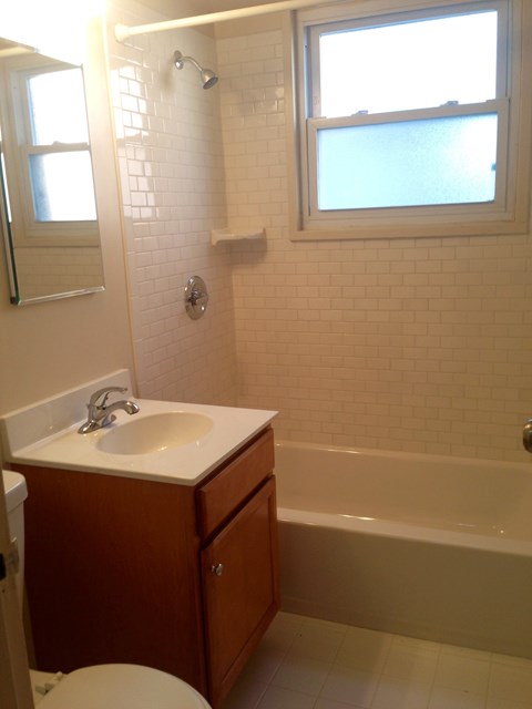 a bathroom with a sink and a toilet and a tub