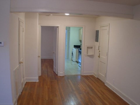 A room with wooden floors and white walls.