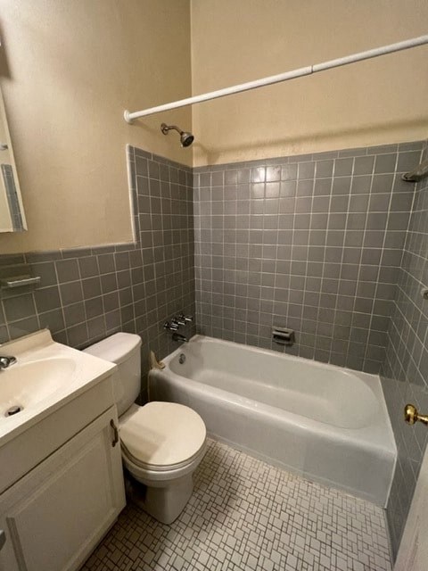 A bathroom with a white toilet and a white bathtub.