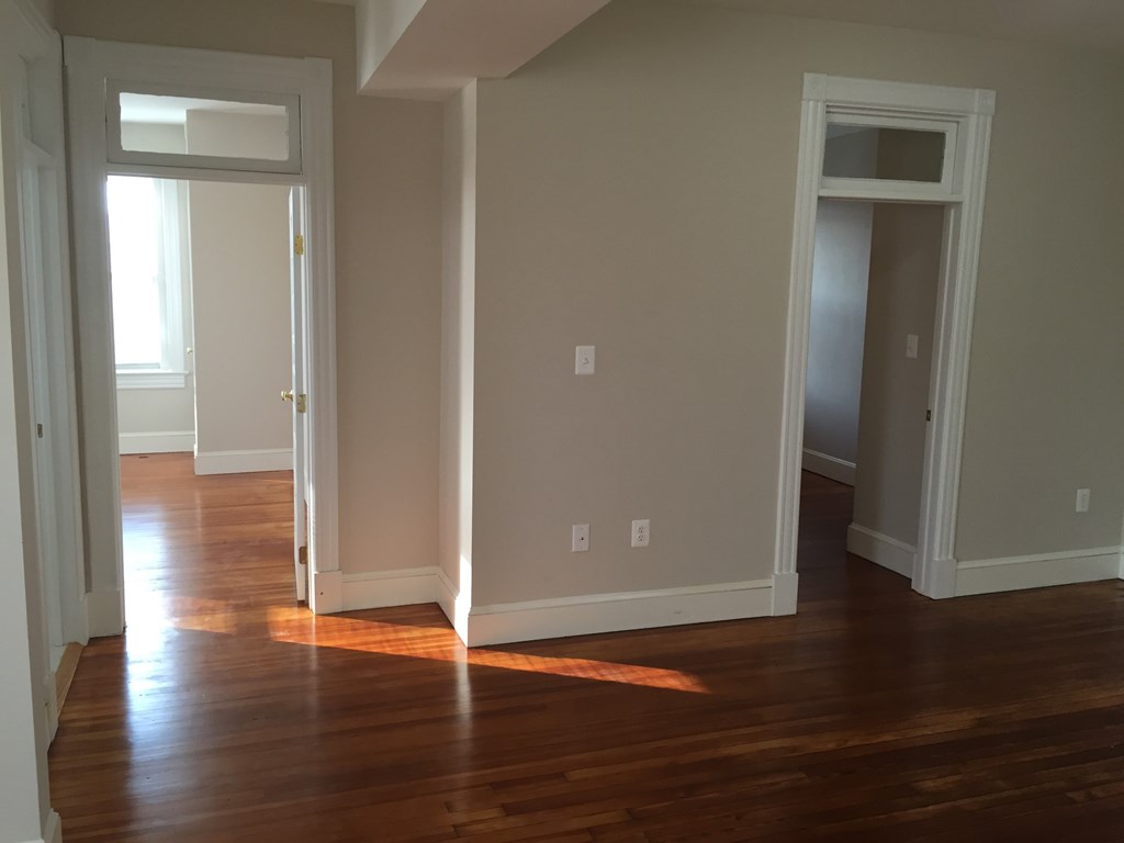 A room with wooden floors and white walls.