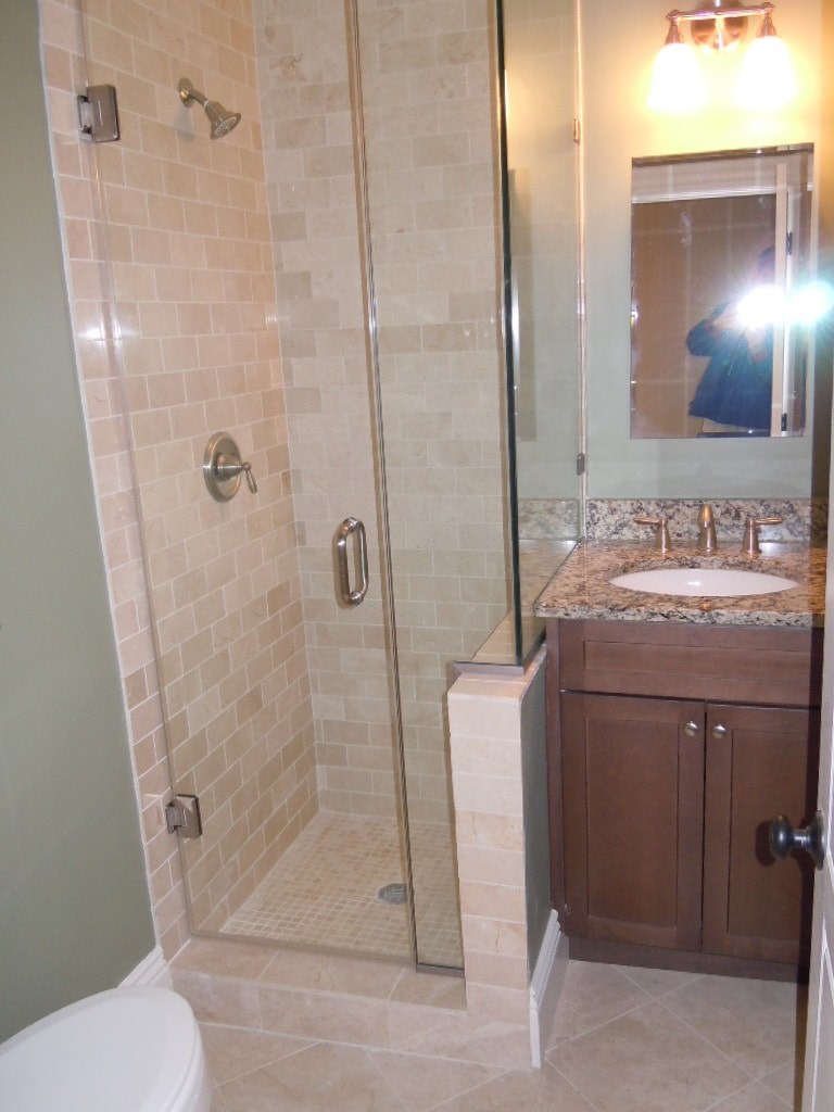 A bathroom with a toilet, sink, and shower.