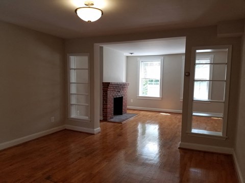 A room with a fireplace and a window.