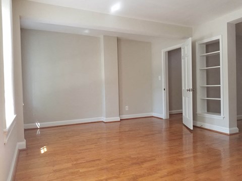 A room with wooden floors and white walls.