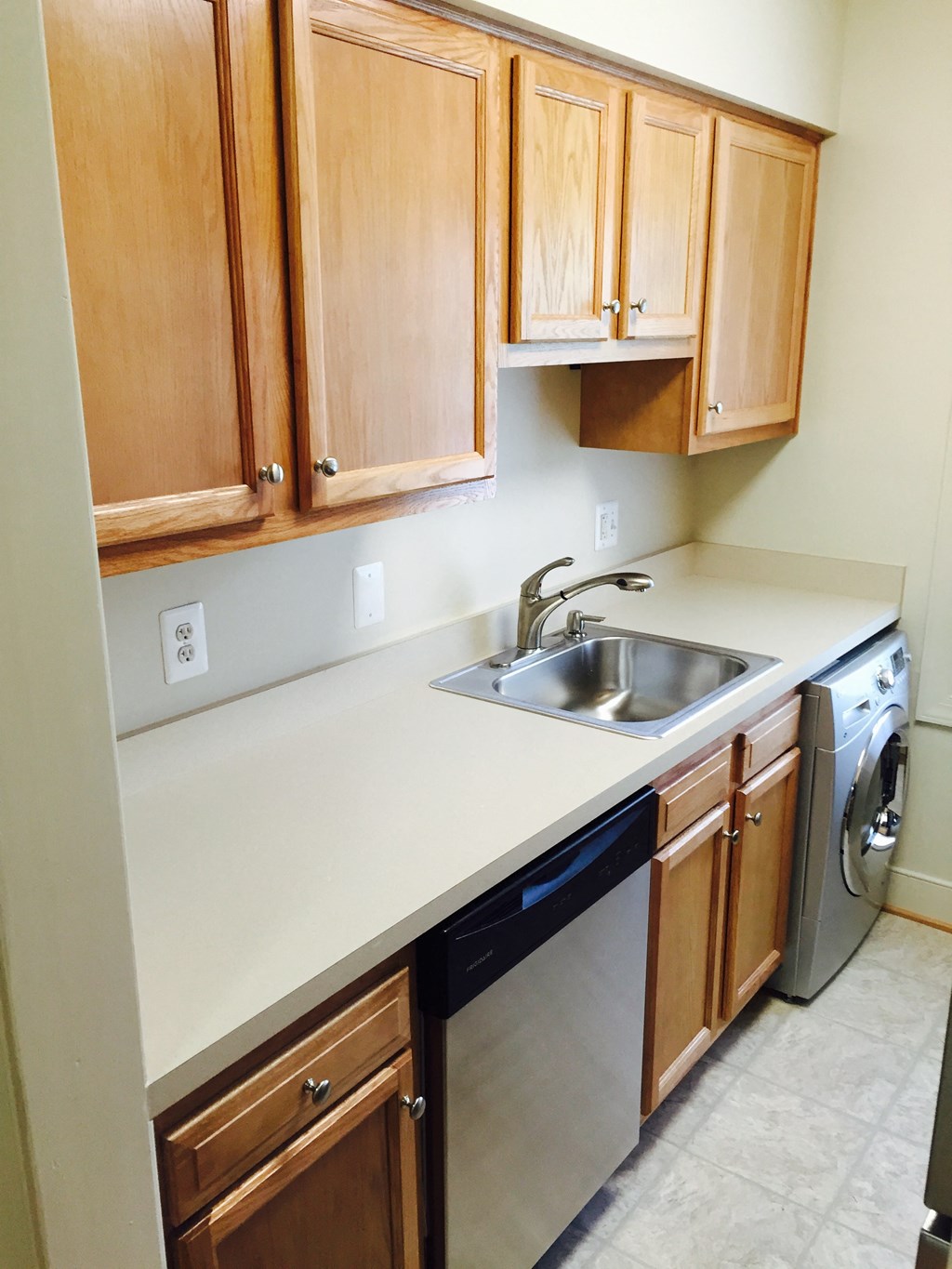 A kitchen with wooden cabinets and stainless steel appliances.