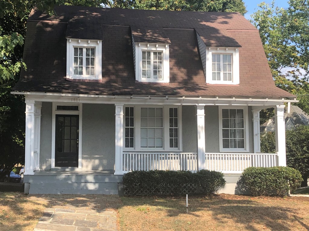 A white house with a black door and windows.
