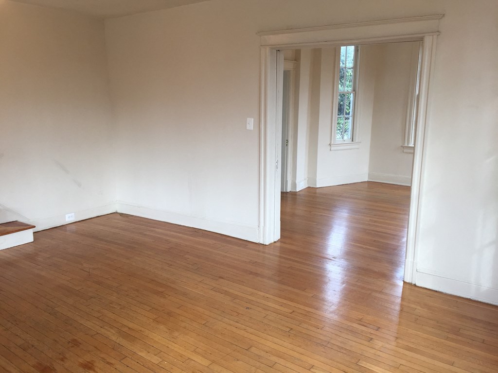 A room with wooden floors and white walls.