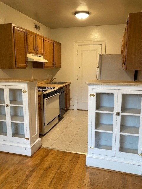 A kitchen with white cabinets and a white door.