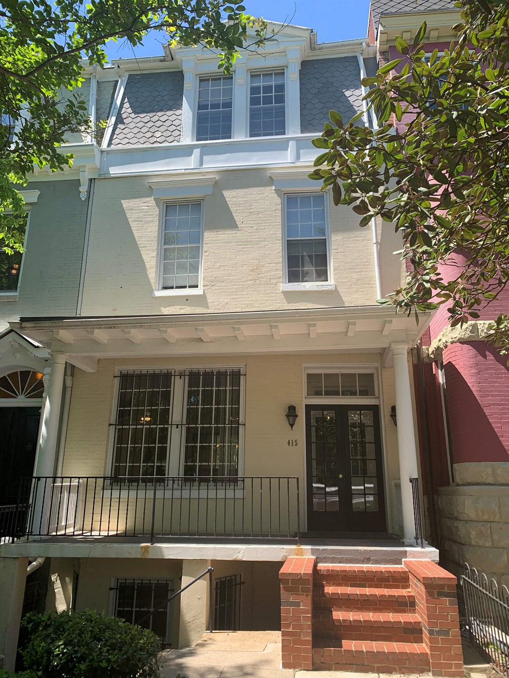 the front of a house with a porch and a staircase