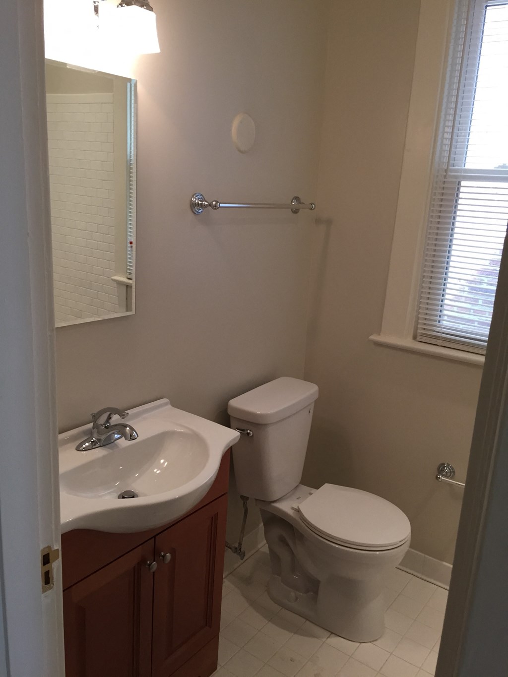 A white toilet sits next to a sink in a bathroom.