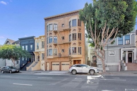 A street view of a residential area with a car parked on the side of the road.