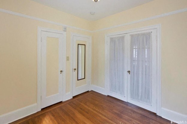 A room with a wooden floor and white walls.