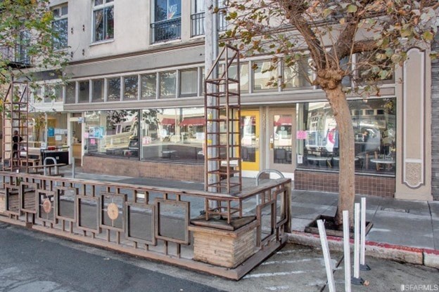 A wooden structure is in the foreground of a street view.