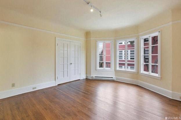 A room with a wooden floor and a white door.