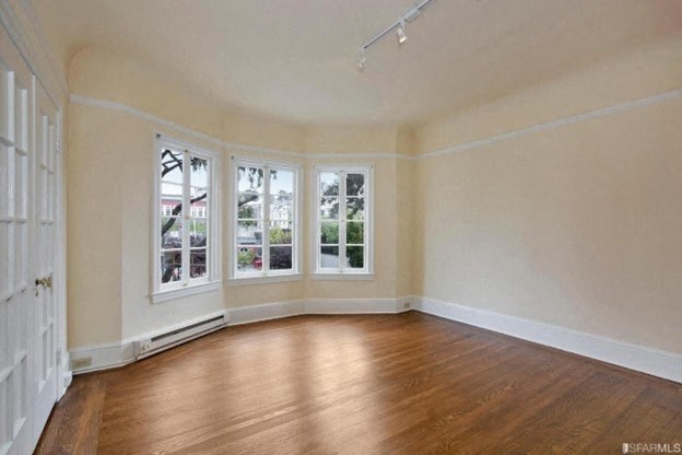 A room with wooden floors and white walls.