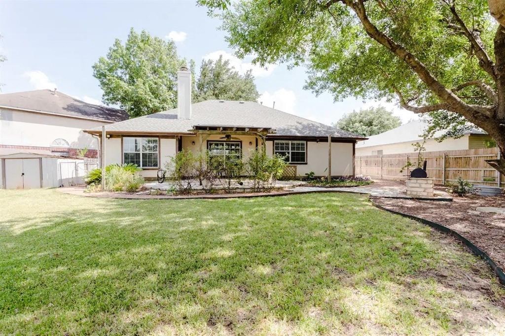 a house with a yard and a tree in front of it