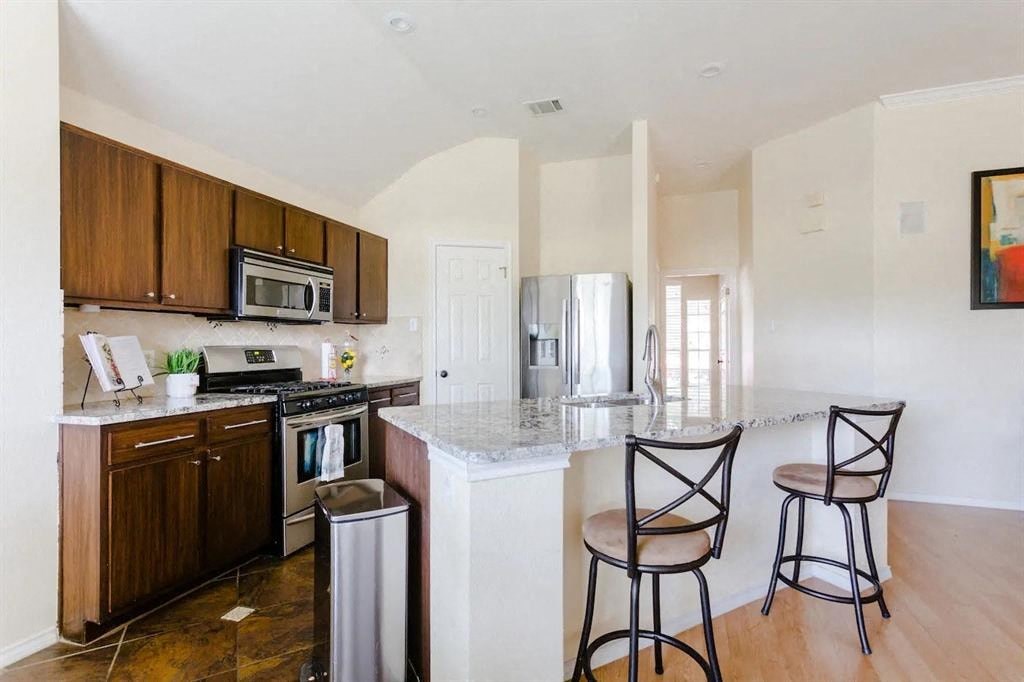a kitchen with an island and two chairs