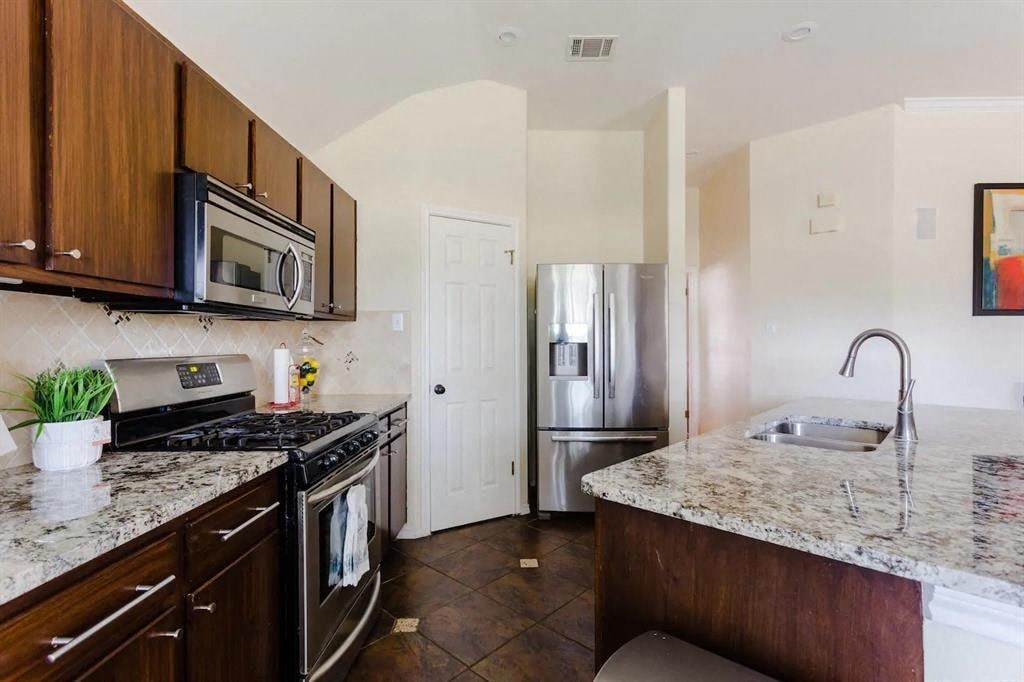 a kitchen with stainless steel appliances and granite counter tops