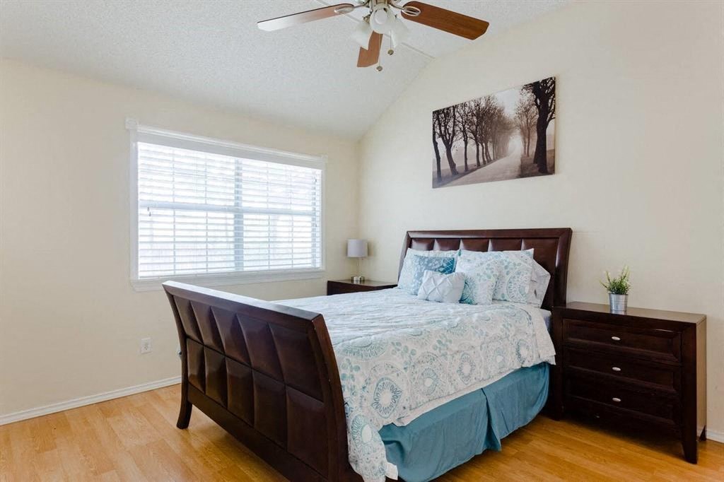 a bedroom with a bed and a ceiling fan