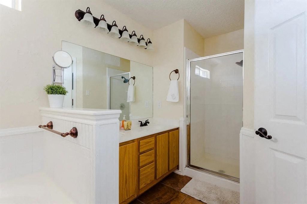 a bathroom with a shower and a sink and a mirror