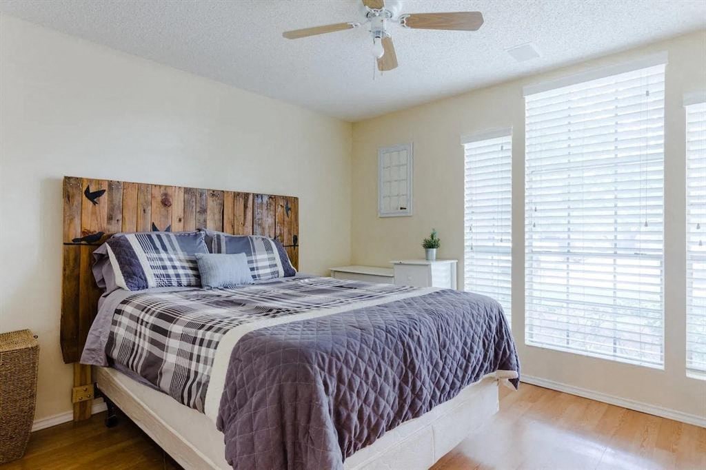 a bedroom with a bed and a ceiling fan