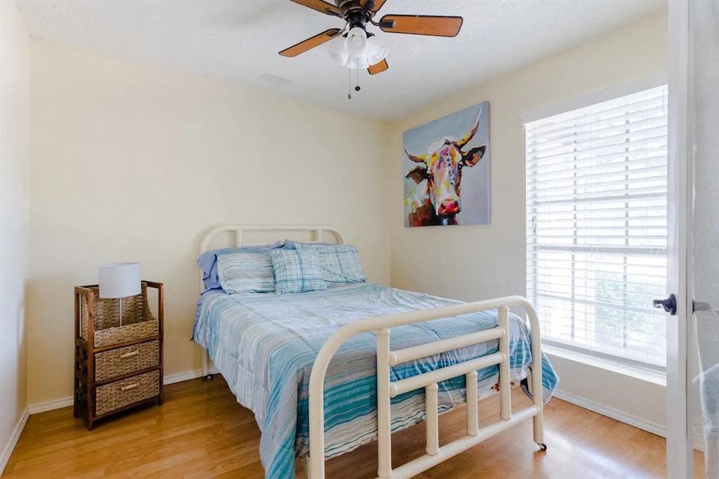 a bedroom with a bed and a ceiling fan