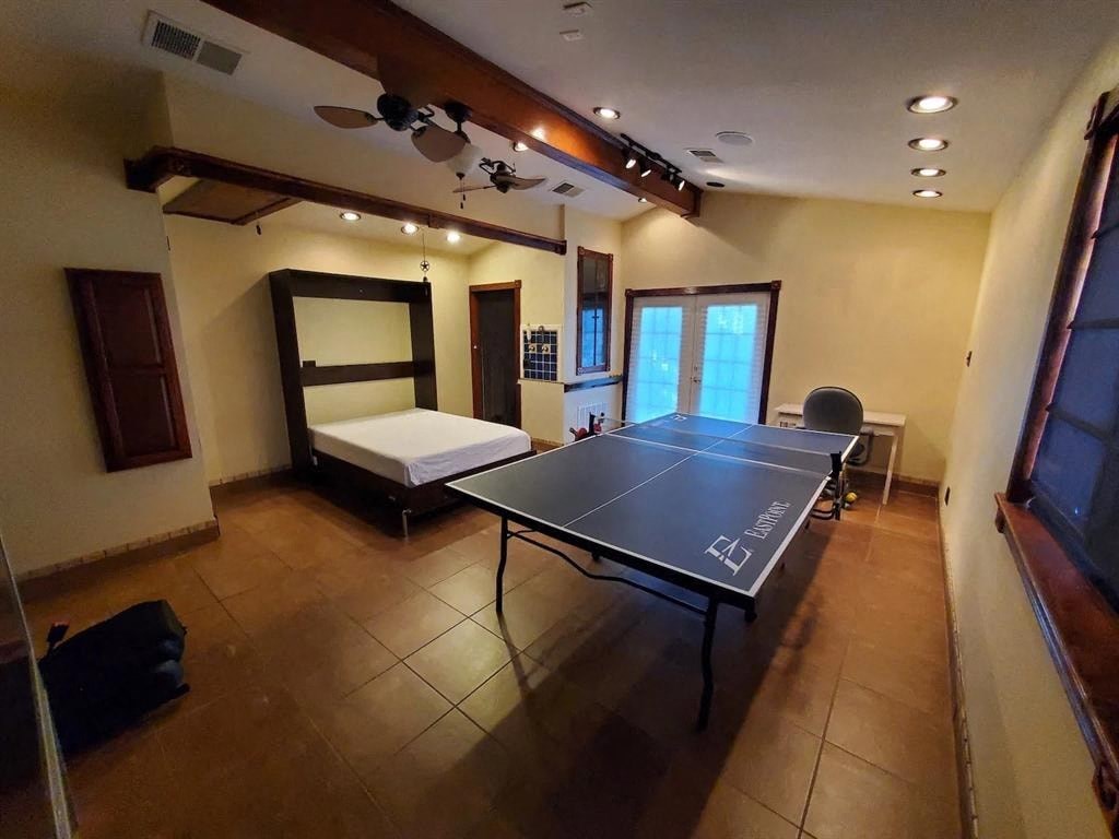 a bedroom with a ping pong table and a bed