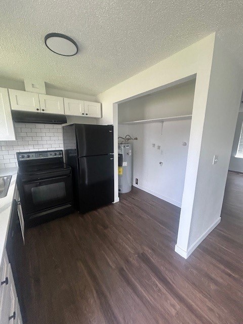 A kitchen with black appliances and white cabinets.