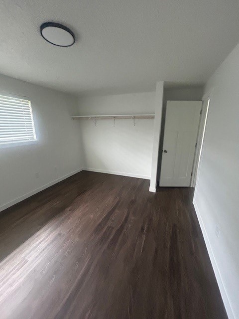 A room with a wooden floor and a white door.