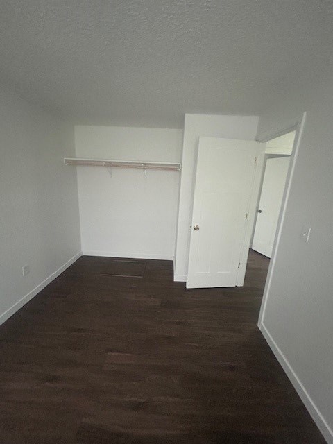 A room with a white door and a white shelf.