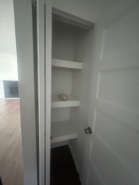 A white door with a shelf underneath it.