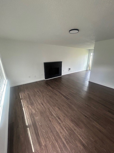 A living room with a fireplace and wood flooring.