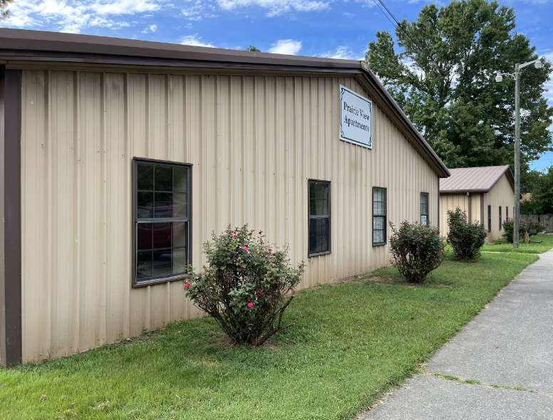 A building with a sign that says "Peace of Mind Apartments".