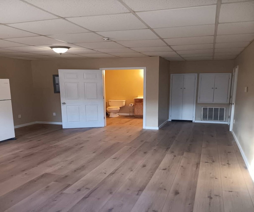 A room with wooden floors and white walls.