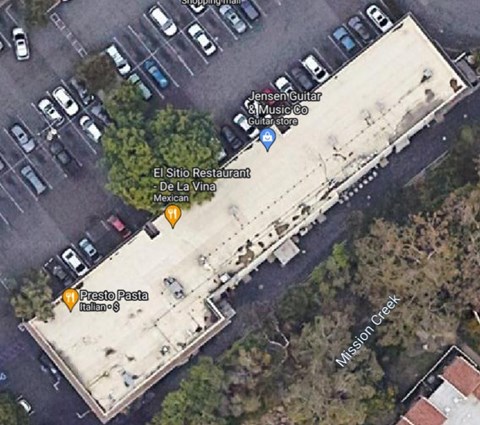 a aerial view of a parking lot and a building