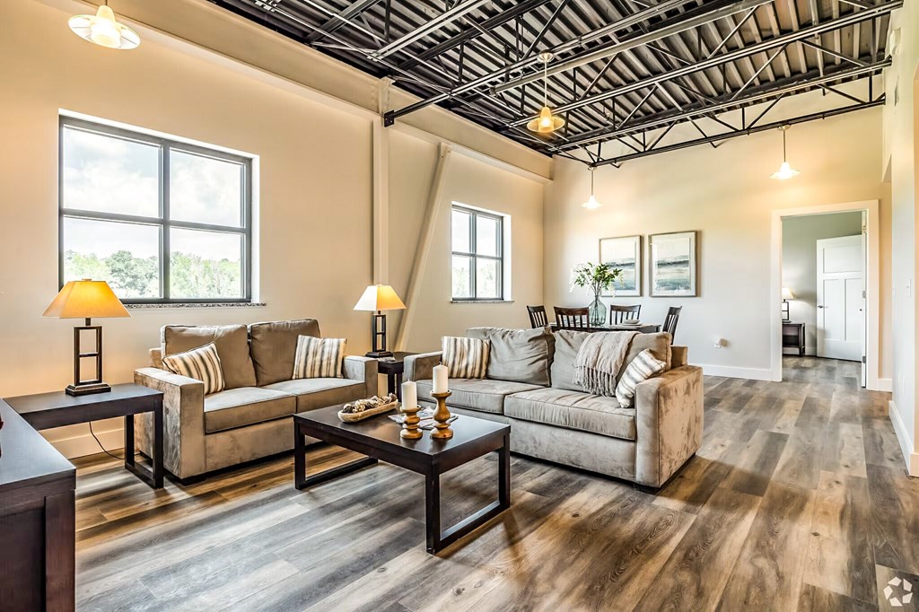 A living room with a couch, coffee table, and two lamps.