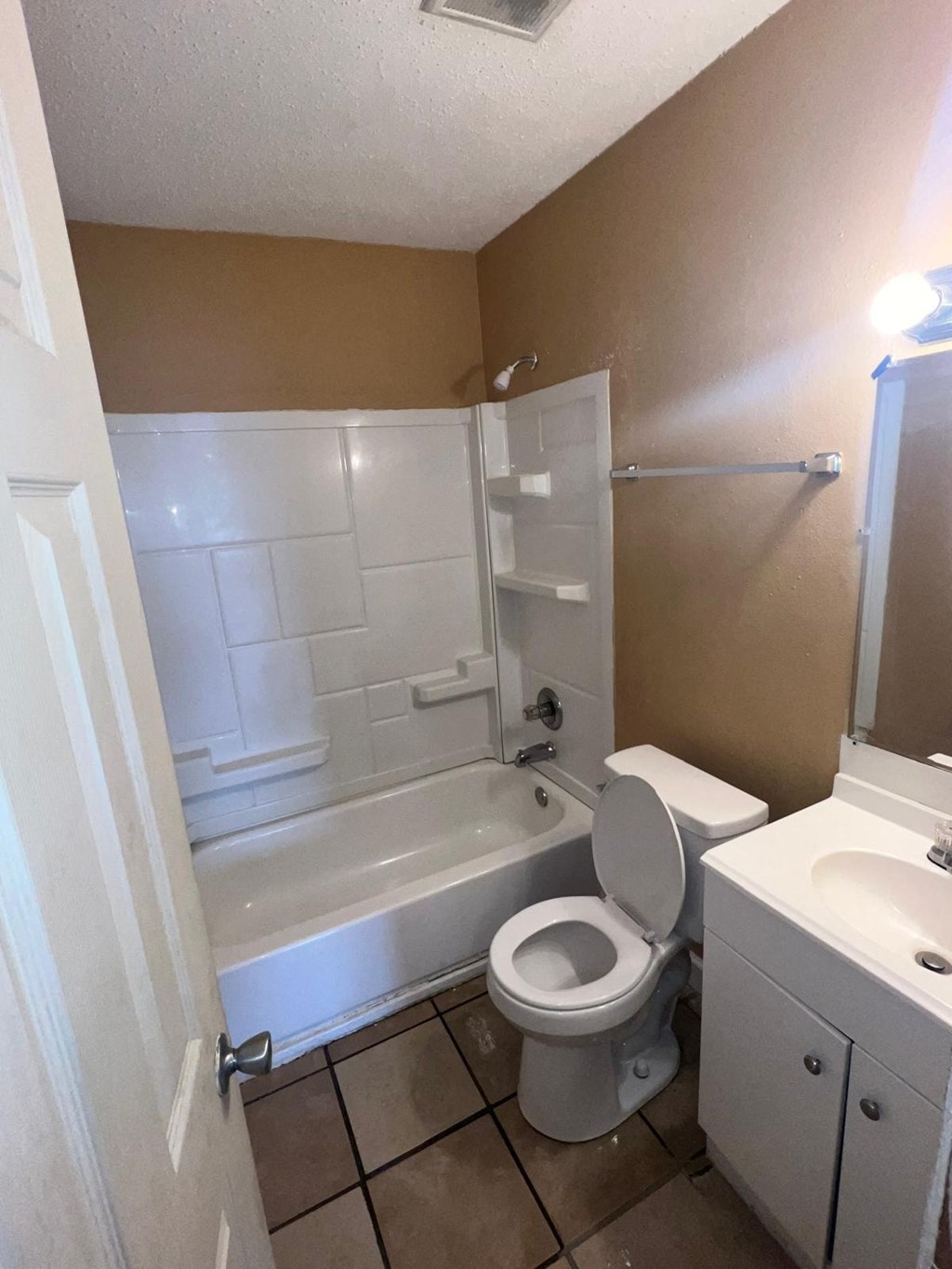 a bathroom with a toilet and a tub and a sink