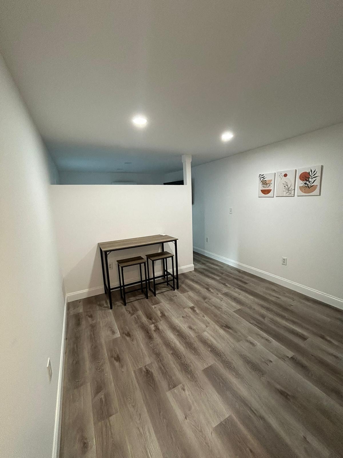 A room with a wooden floor and a table in it.