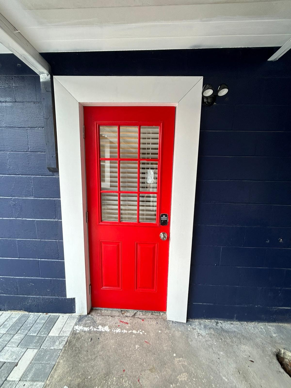 A red door with a white frame and a black handle.