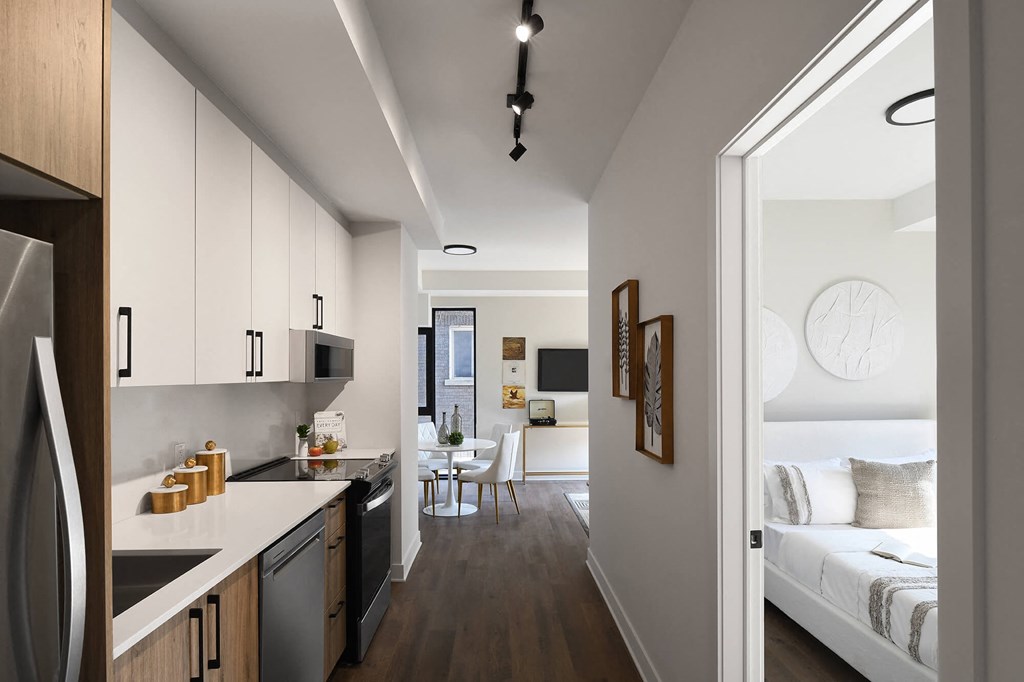 a kitchen and living room with a view of a bedroom