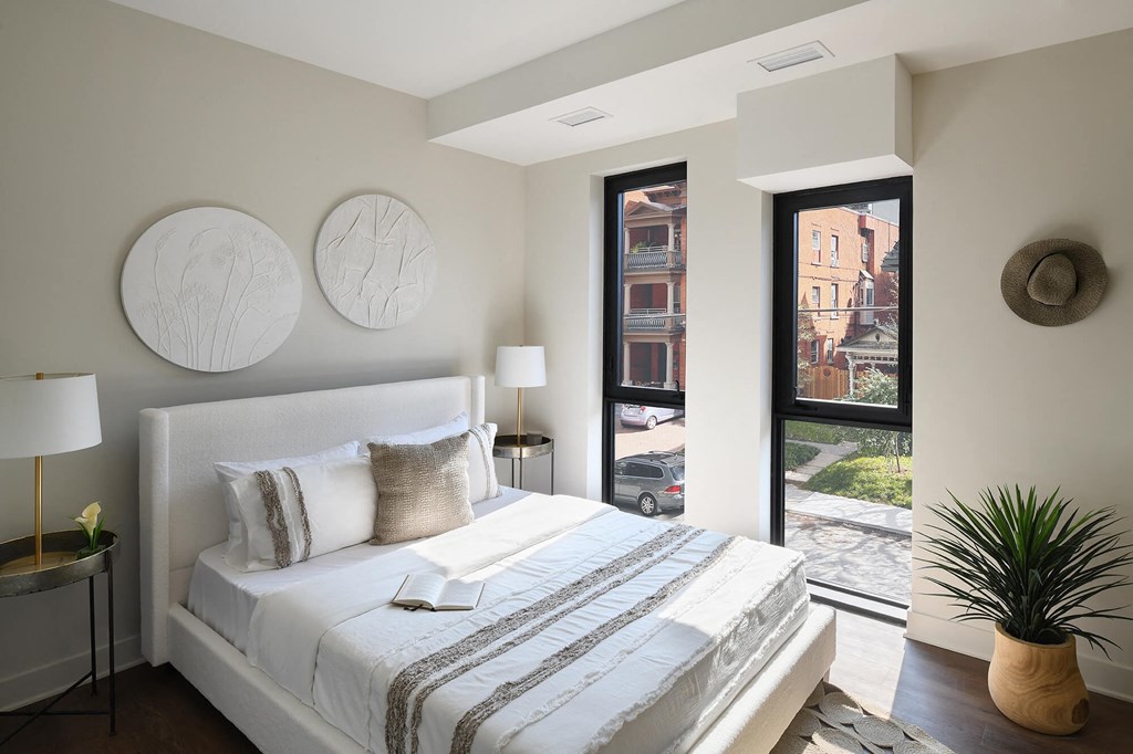 a bedroom with a bed and a door to a balcony