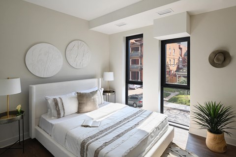 a bedroom with a bed and a door to a balcony